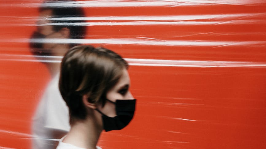 people wearing face mask standing side by side